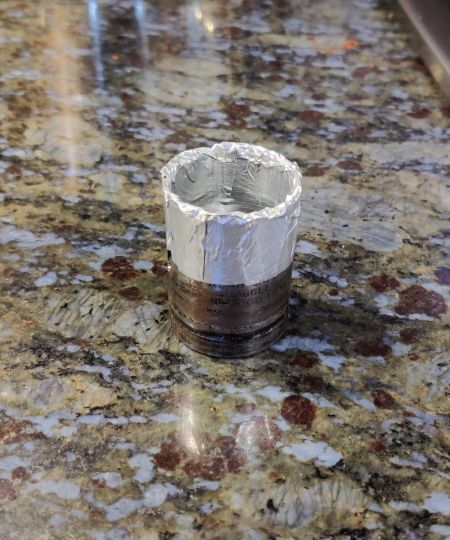 2. Covering an 1.25" hole saw drill bit with aluminum foil tape and covered an 18mm socket with the same material to reach a diameter of 0.98"