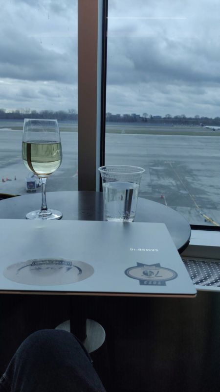 Enjoying a pre-trip glass of wine before my overnight flight