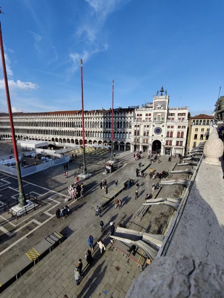 Looking down at the square, watching the time change on the clock, and watching the mechanized bell whackers operate