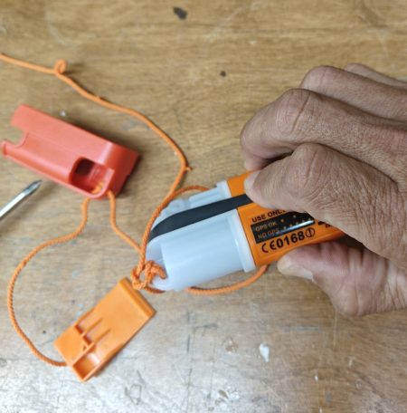 Hold the antenna while removing the red clip then immediately press and hold the OFF button until the unit powers down