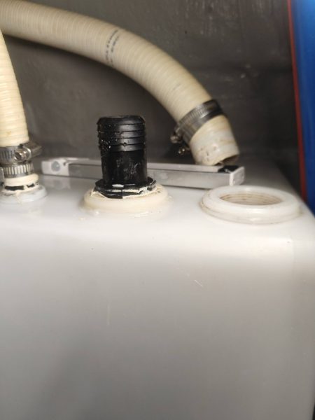 Hose removed and the drain plug removed from the top of the holding tank